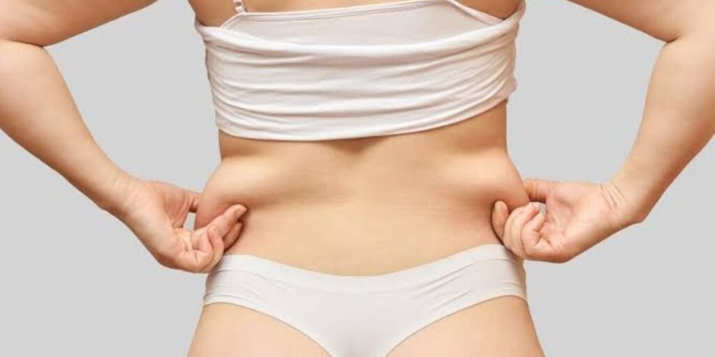 Medical professional discussing liposuction results and changes in body fat with a patient during a cosmetic consultation | Can Fat Come Back After Liposuction?