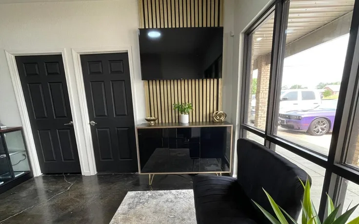 Waiting-area seating by the front window at Lux Lipo